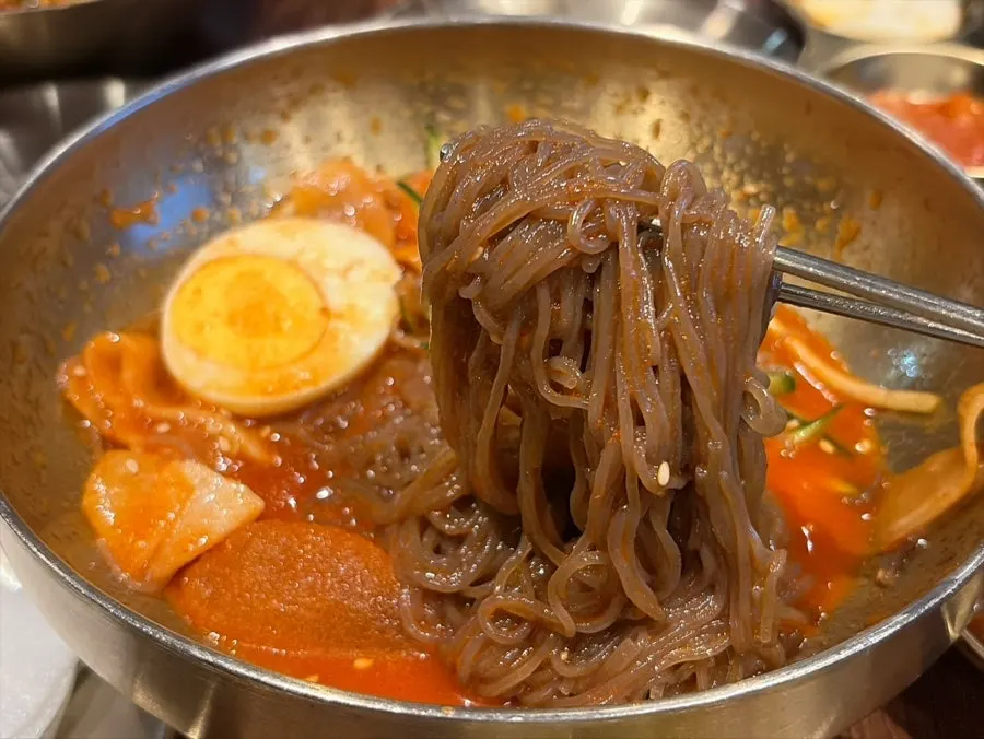 Close-up of the mixed bibim naengmyeon noodles