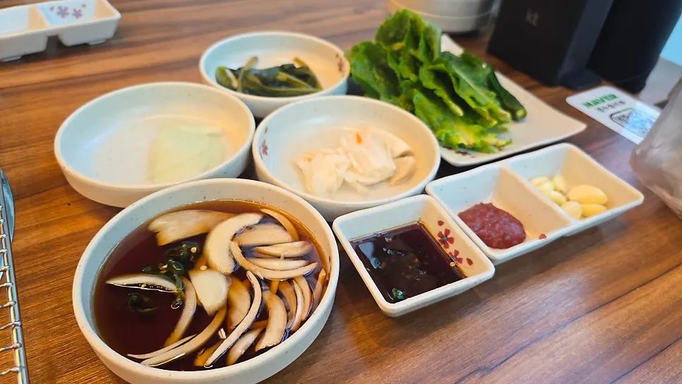 Pickled onions, ssammu, myeongi namul, and baek kimchi side dishes