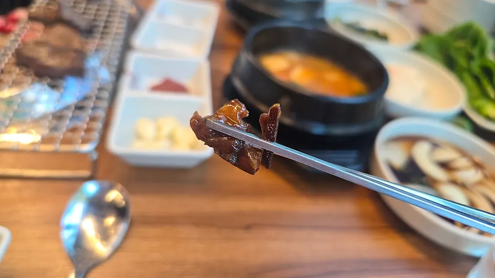 A piece of rib dipped in shiitake wasabi sauce