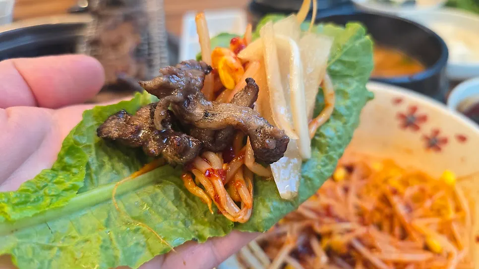 Wrapping the meat left on the bone into a lettuce wrap