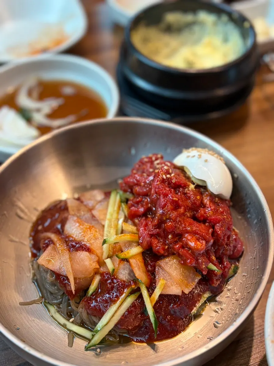 Yukhoe bibim naengmyeon topped with a generous amount of raw beef