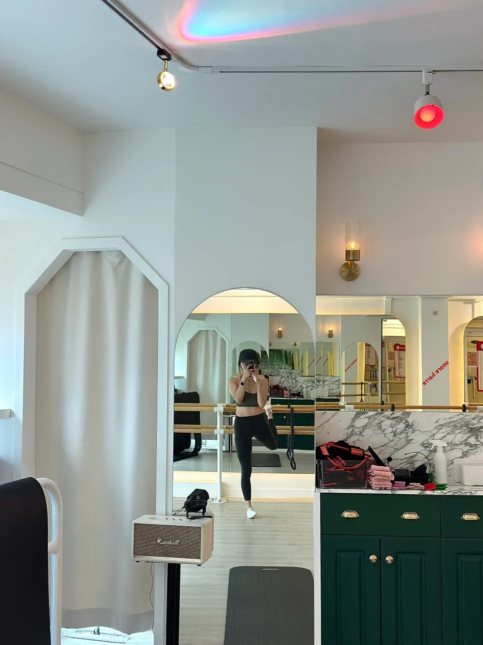 The barre group class space, run with music playing