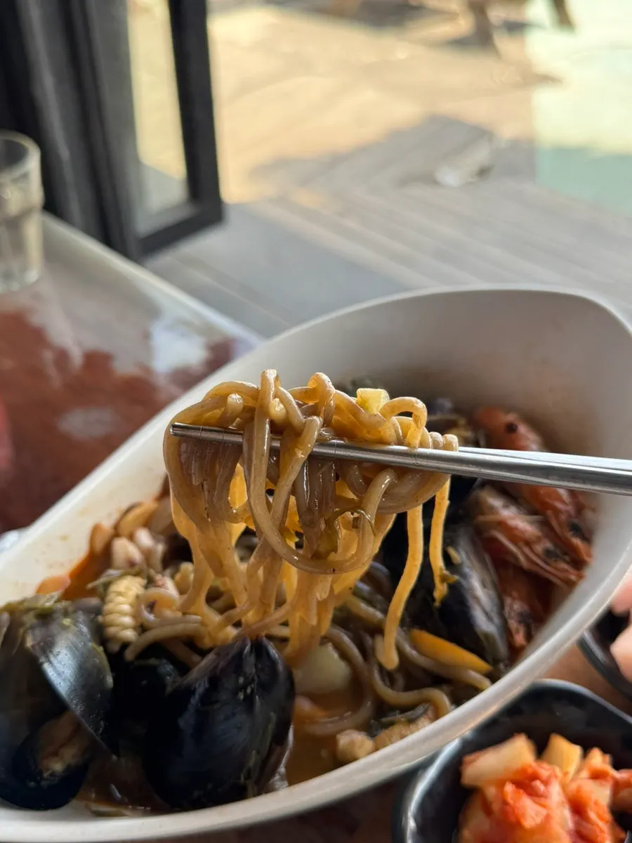 Brownish-tinted ujjamppong noodles made with tot