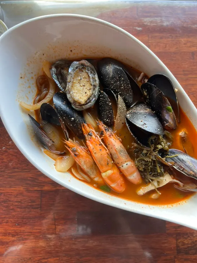 A bowl of spicy ujjam broth