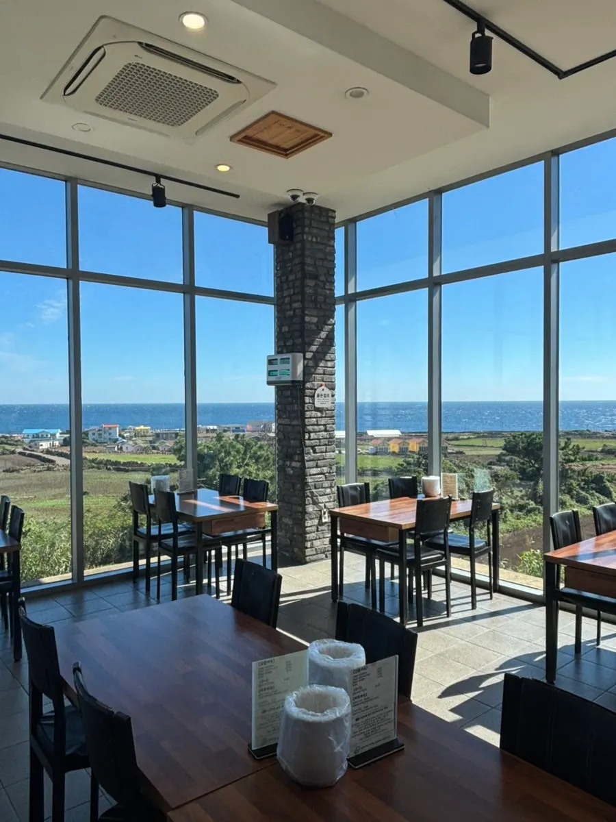 Seating with a sea view through Soseom Jeonbok's floor-to-ceiling windows
