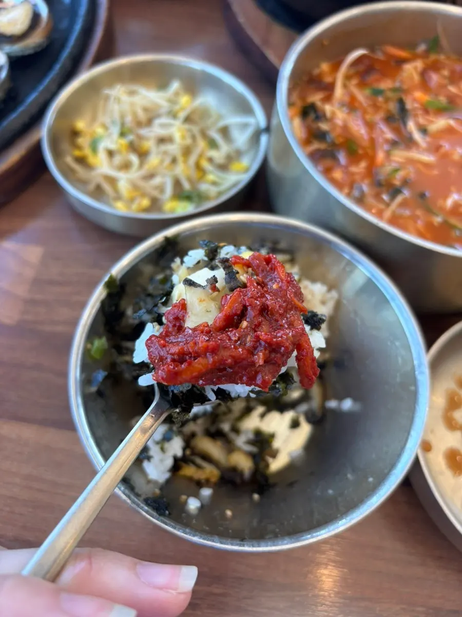 Side dishes including black pork skewer and abalone innards jeotgal