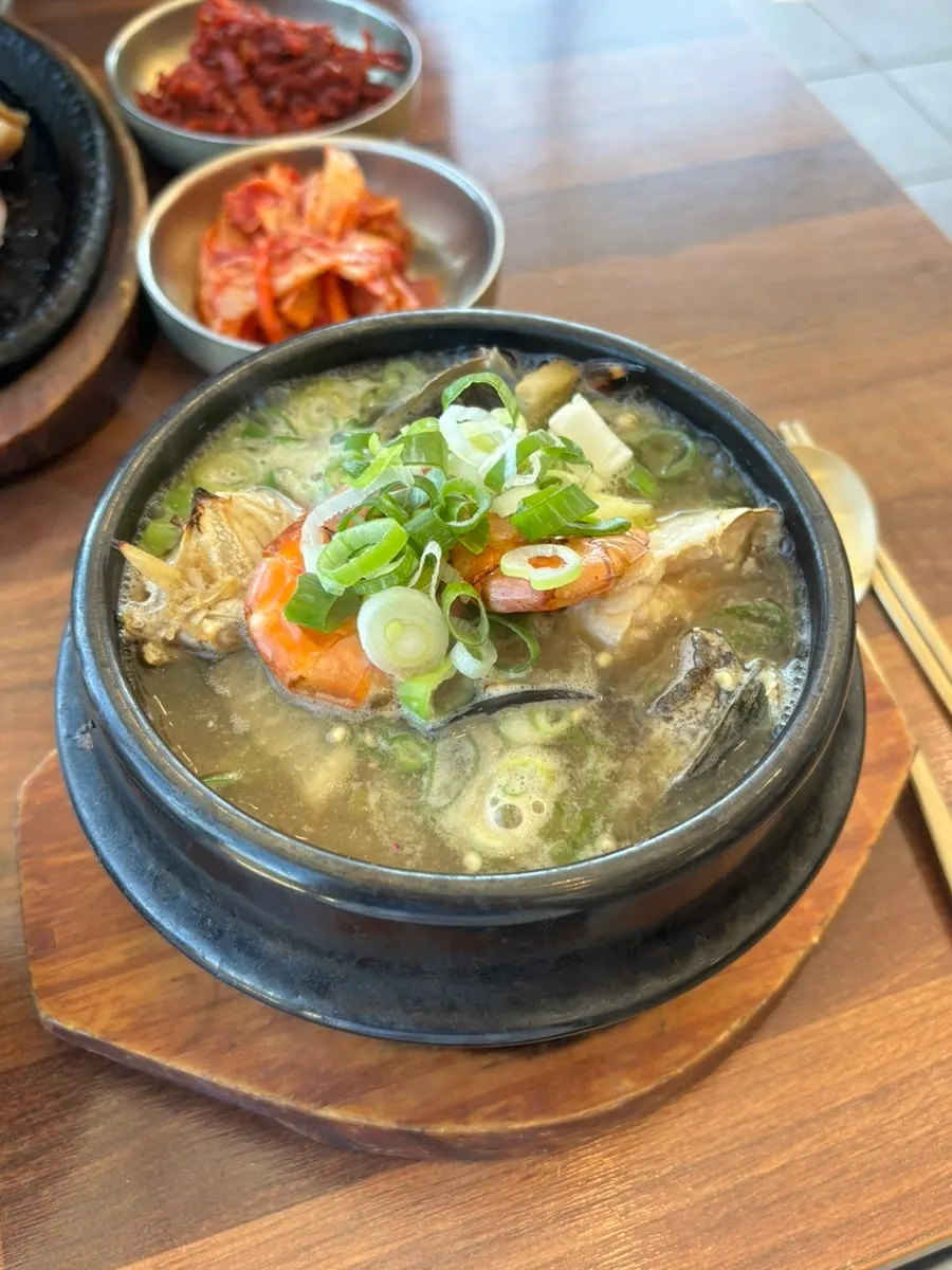 A close-up of abalone and seafood inside the hotpot