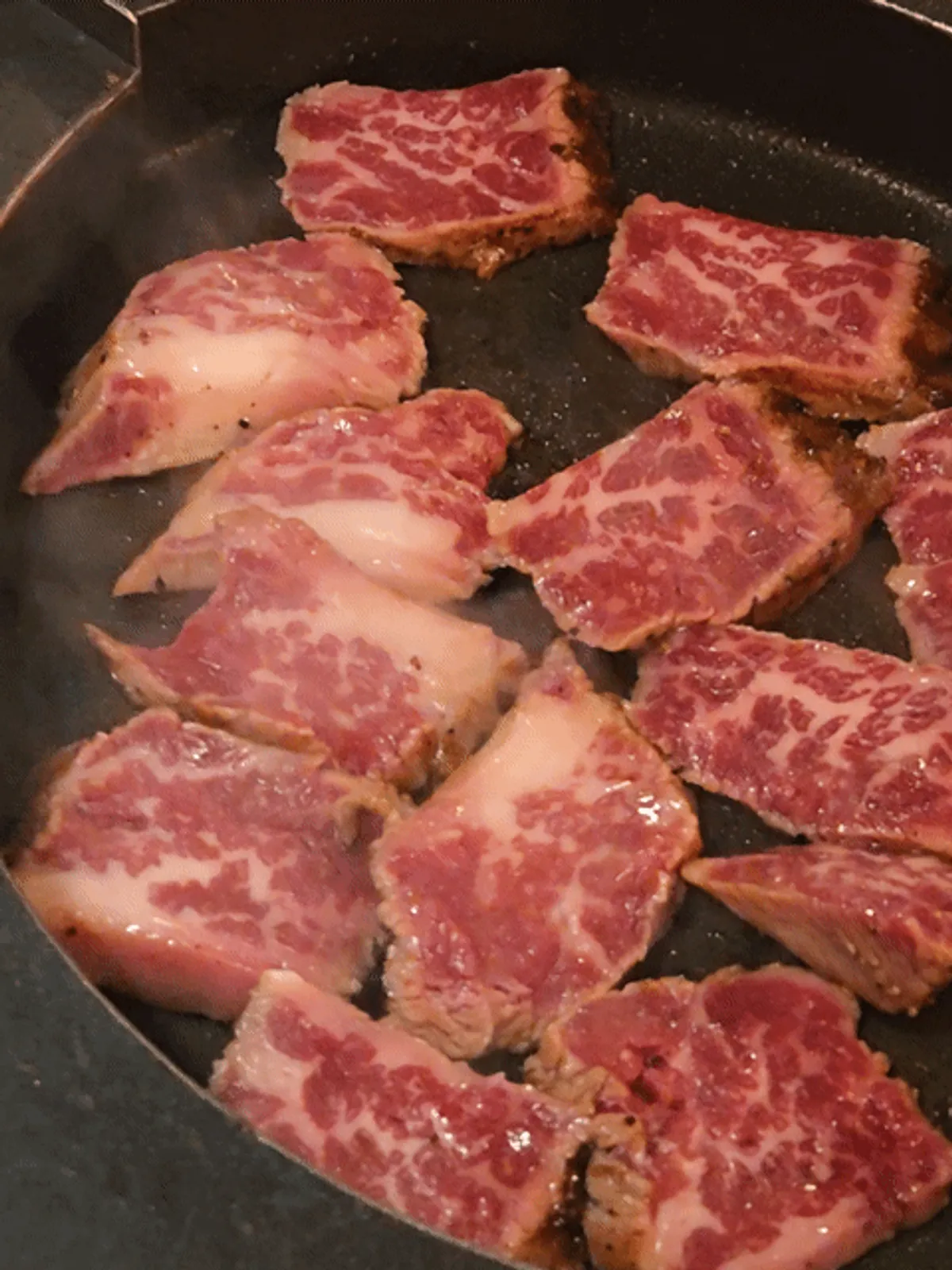 Staff member grilling the woodae galbi