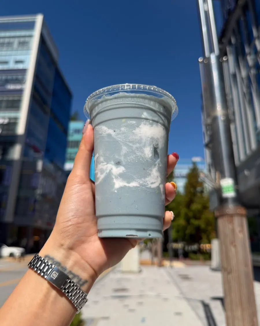 Stress Down smoothie held against a blue sky