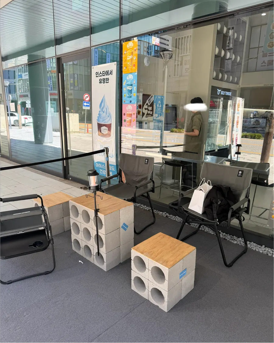Camping chairs and a small table outside Ugly Tongue