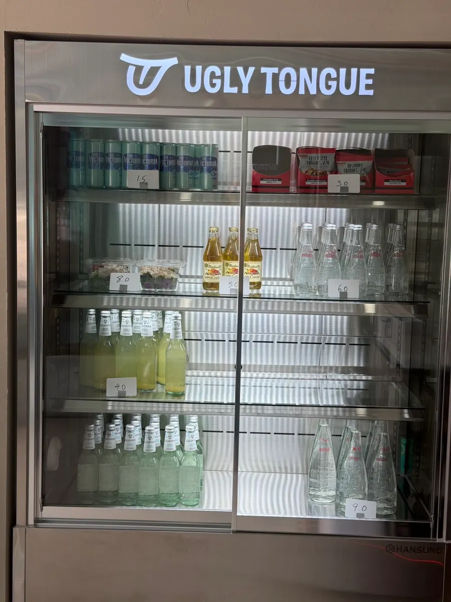 Refrigerated display with bottled drinks, cookies, and salads