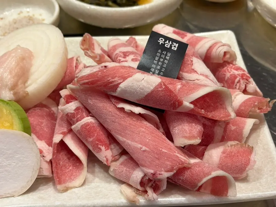 Basic side dishes and meat set on the table at Ugojip
