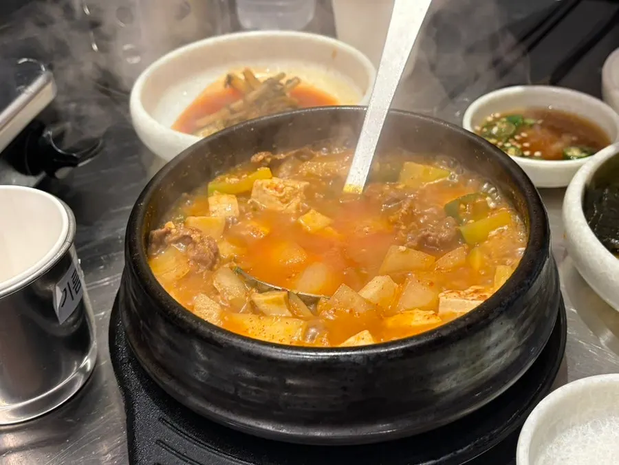 Doenjang jjigae served in a big pot with rice