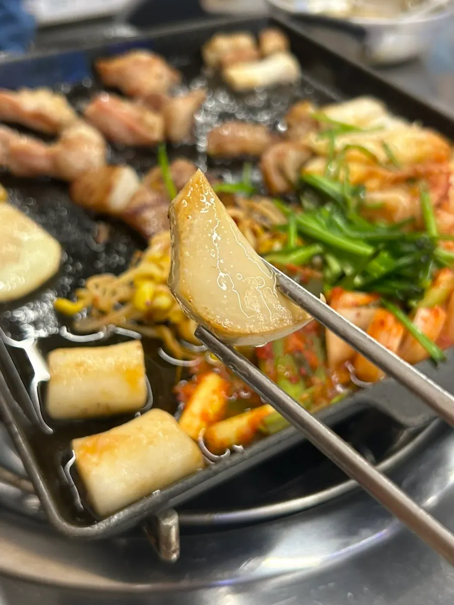 직원이 구워주는 곱창과 불판 위 야채