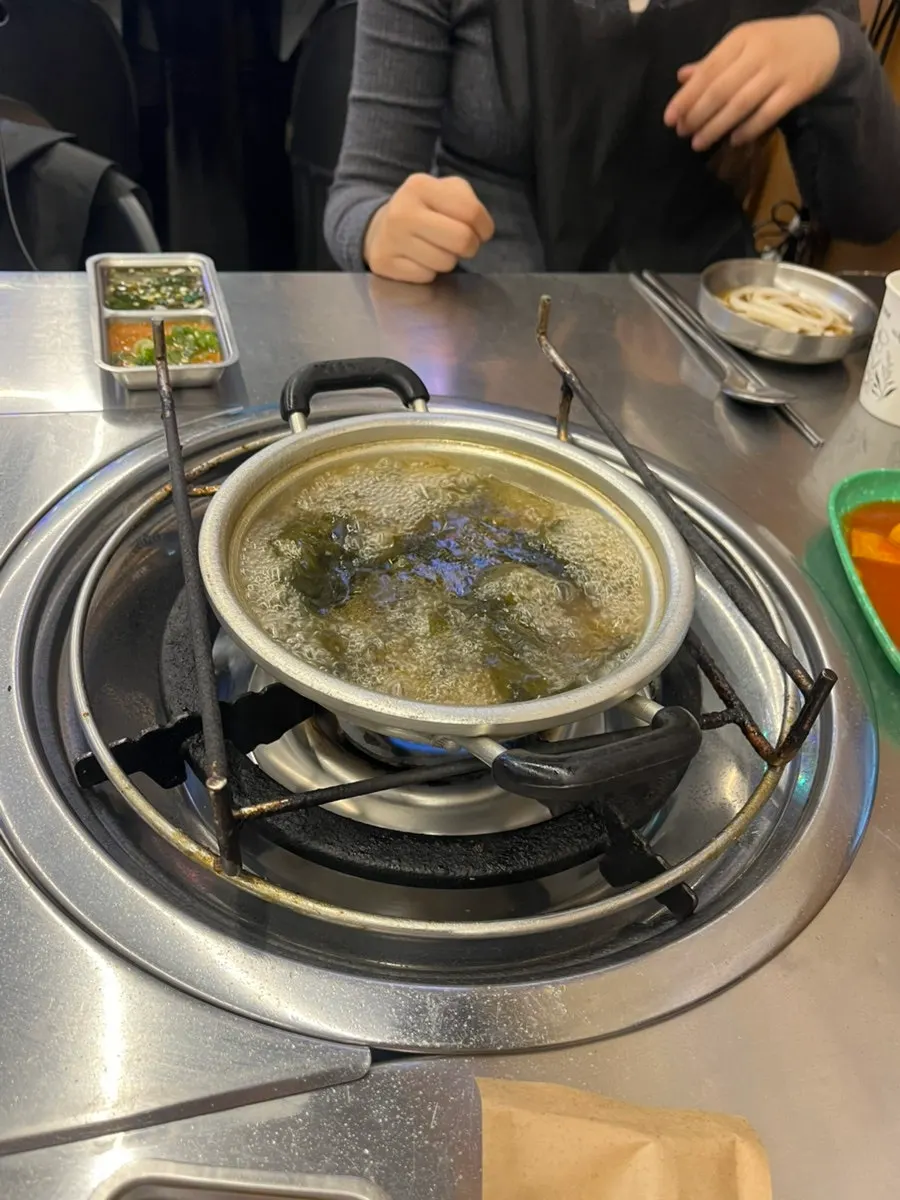 Side dish spread with seaweed soup and tteokbokki at Uhwa Gopchang