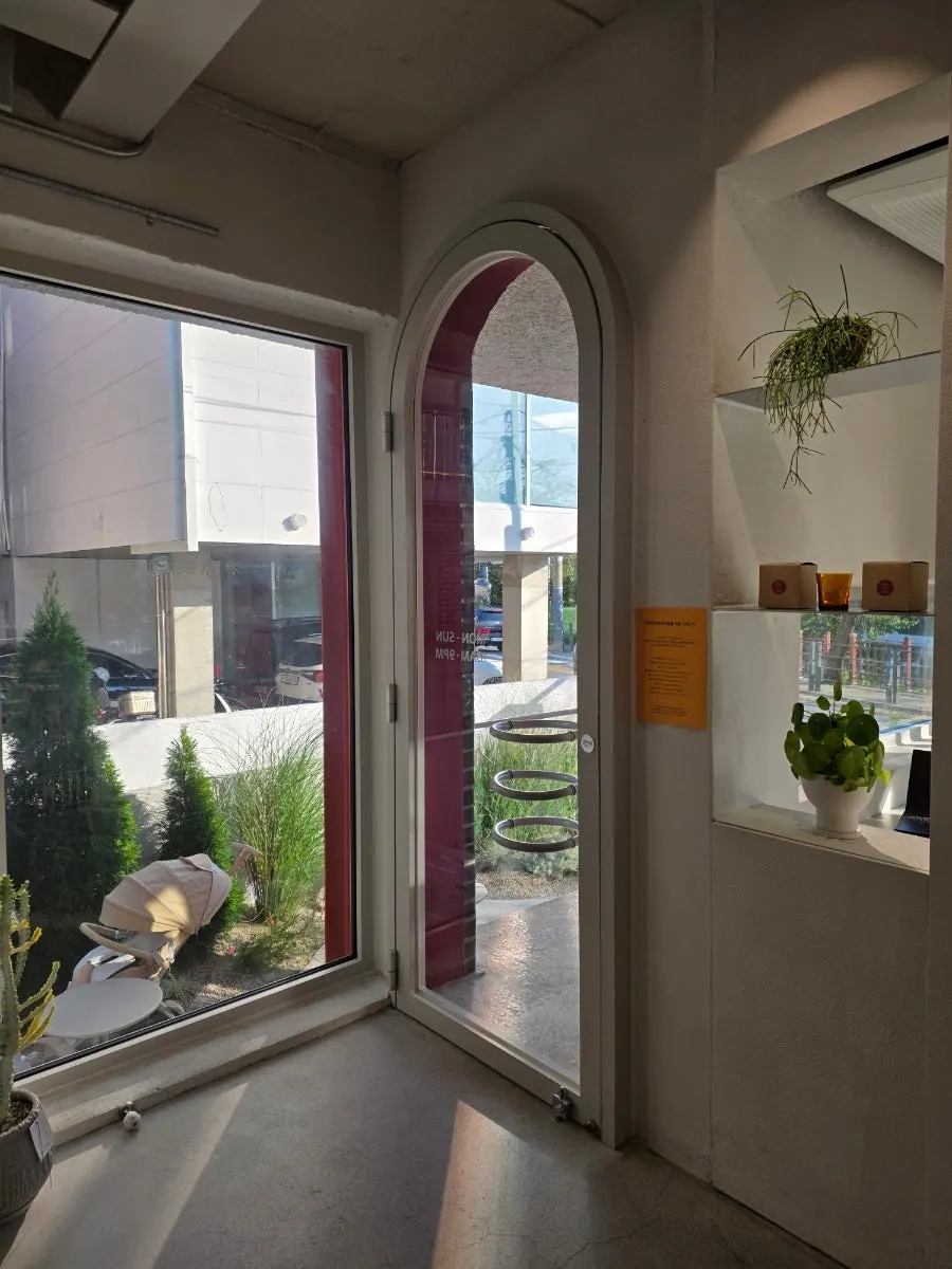 First-floor room lit by sunlight through large windows