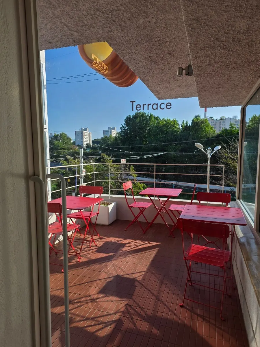 Outdoor terrace with red tables