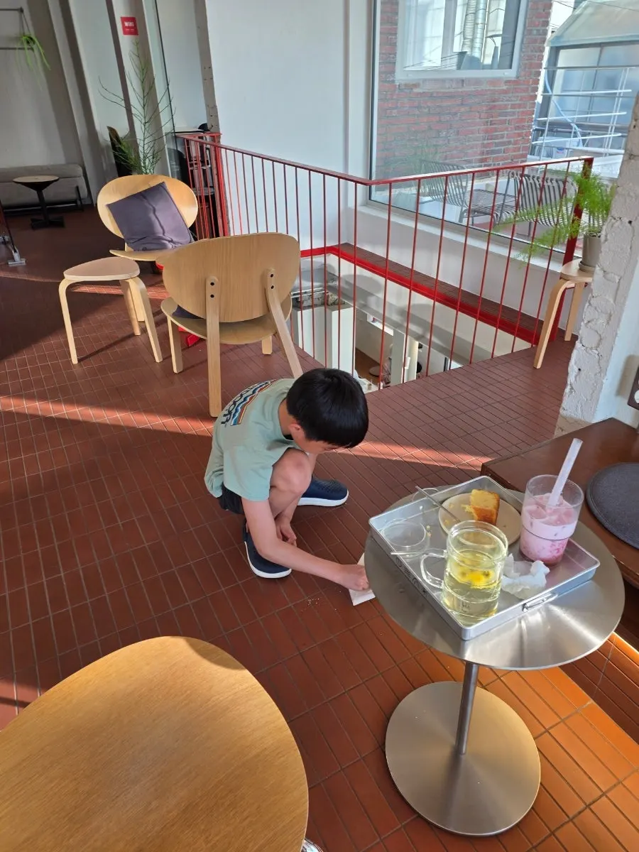 Child cleaning up bread crumbs