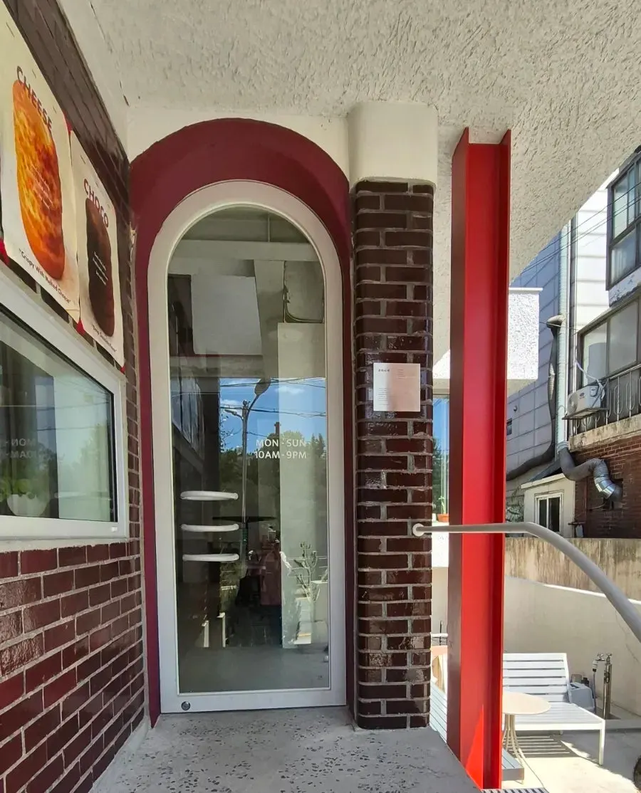 Arched glass door and burgundy entrance
