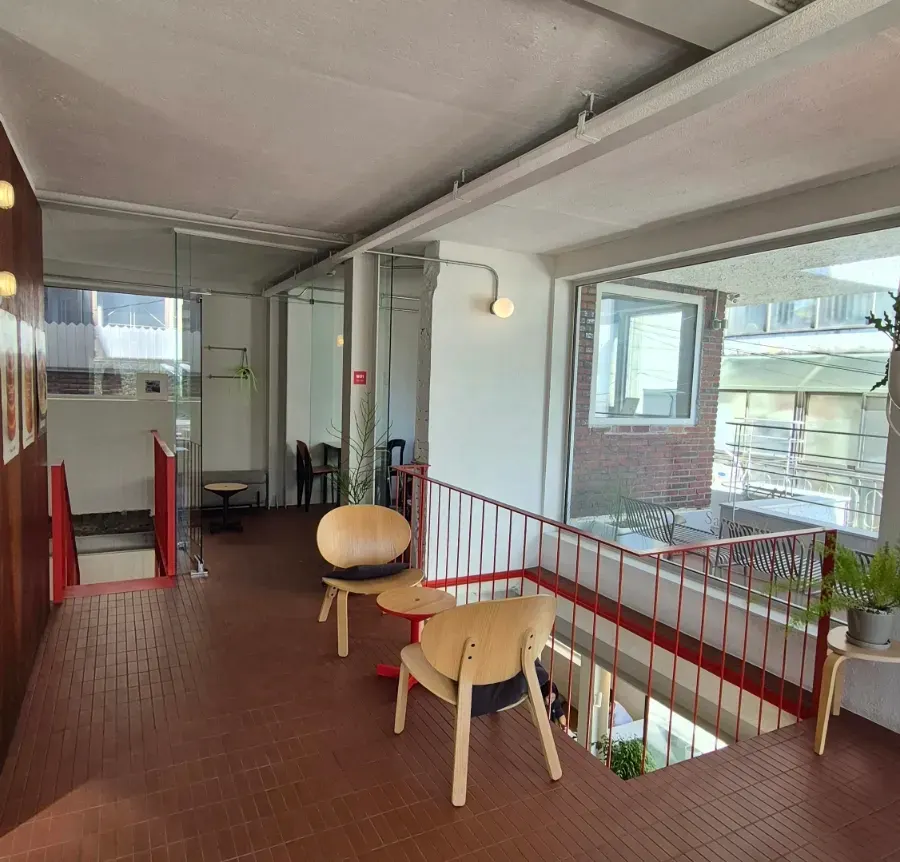 Varied second-floor seating along full-height windows