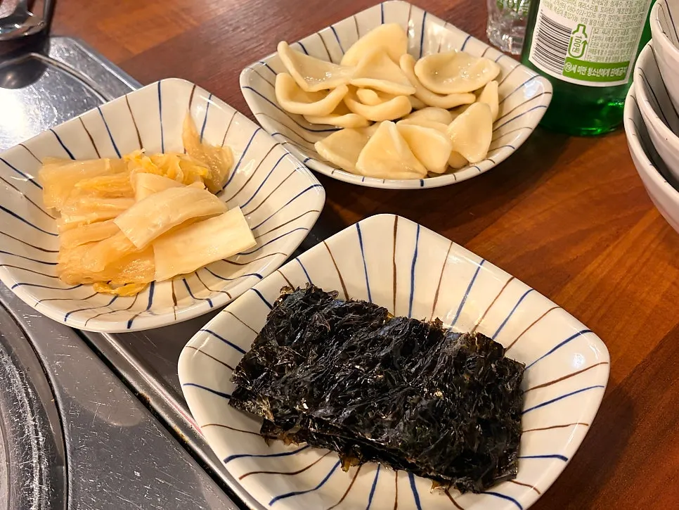 Aged kimchi and seaweed served alongside the sashimi