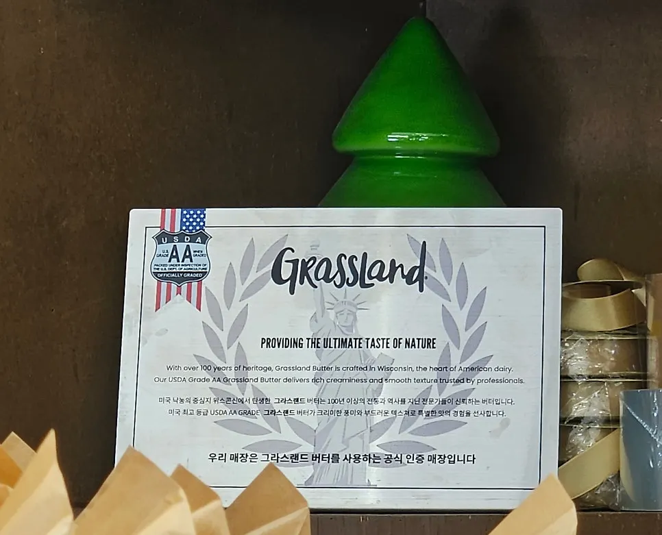 Sign confirming official Grassland butter certified shop status