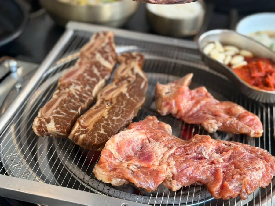 Marinated galbi cooking over charcoal