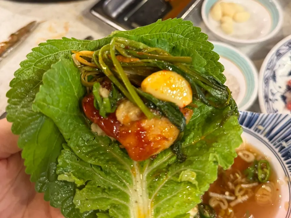 Thick pork belly served with minari