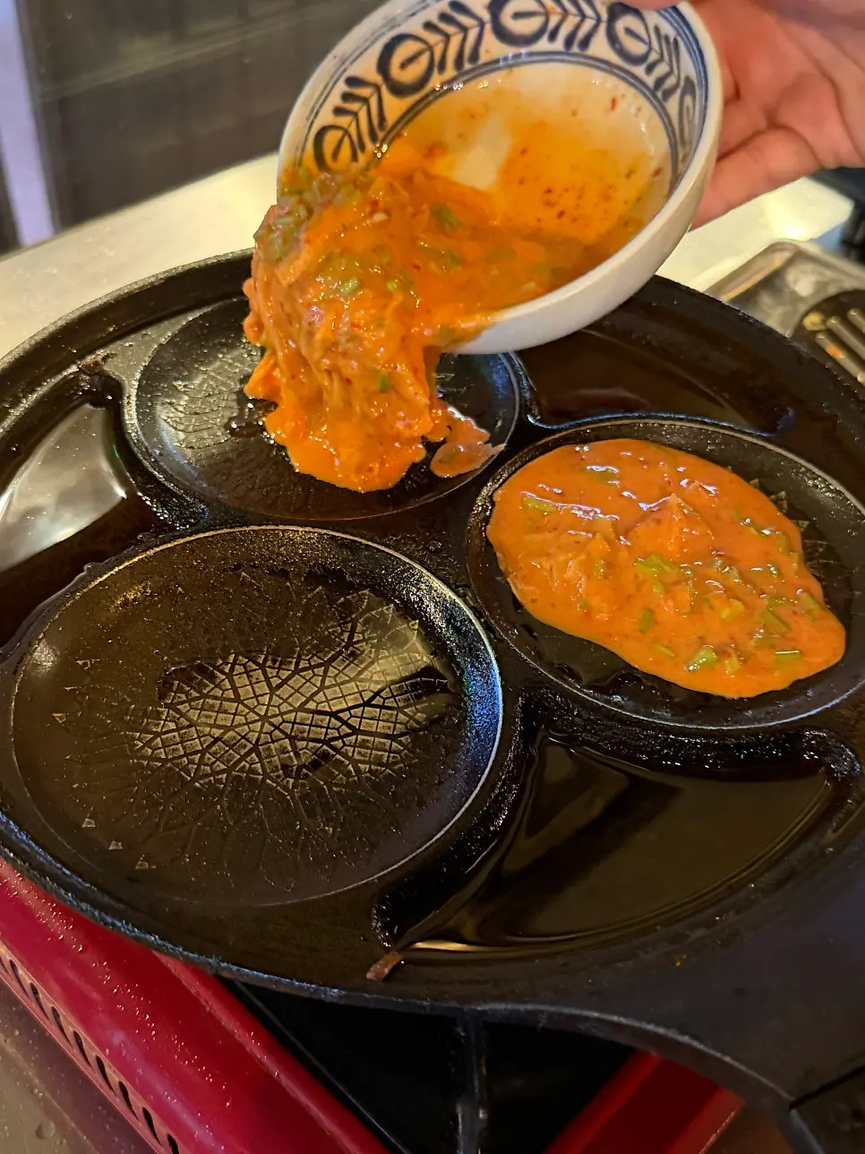 Minari-kimchi pancake batter grilled at the table