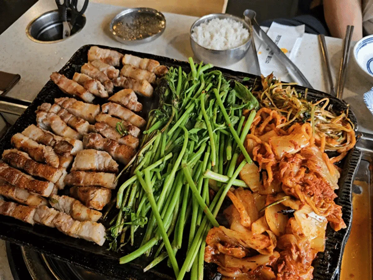 Image of a full table including beef tartare and spicy doenjang