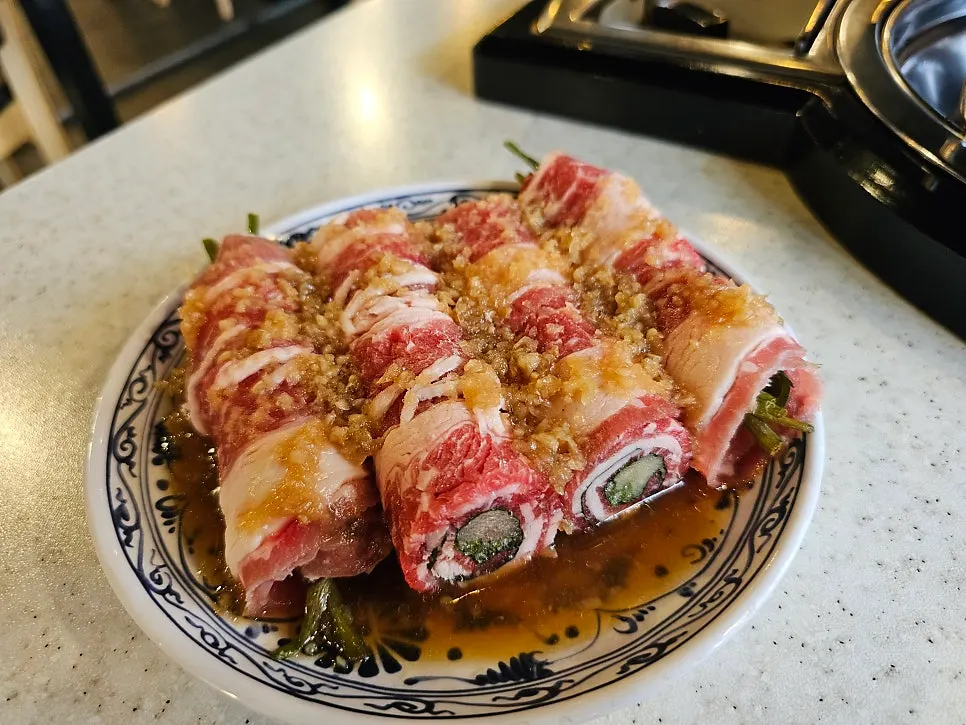 Image of beef rolls grilling on the grill plate