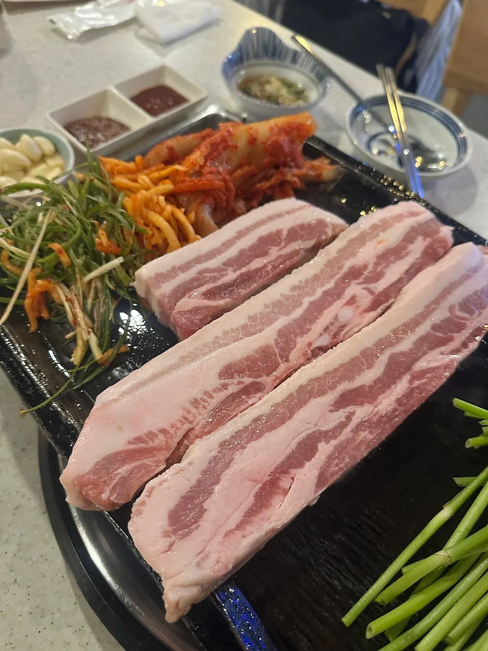 Grilling the thick-cut aged pork belly