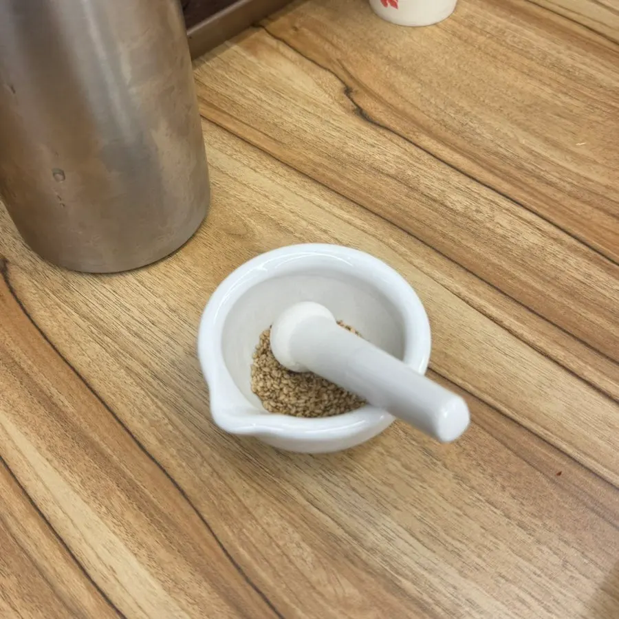 Mini mortar and sesame seeds on the table