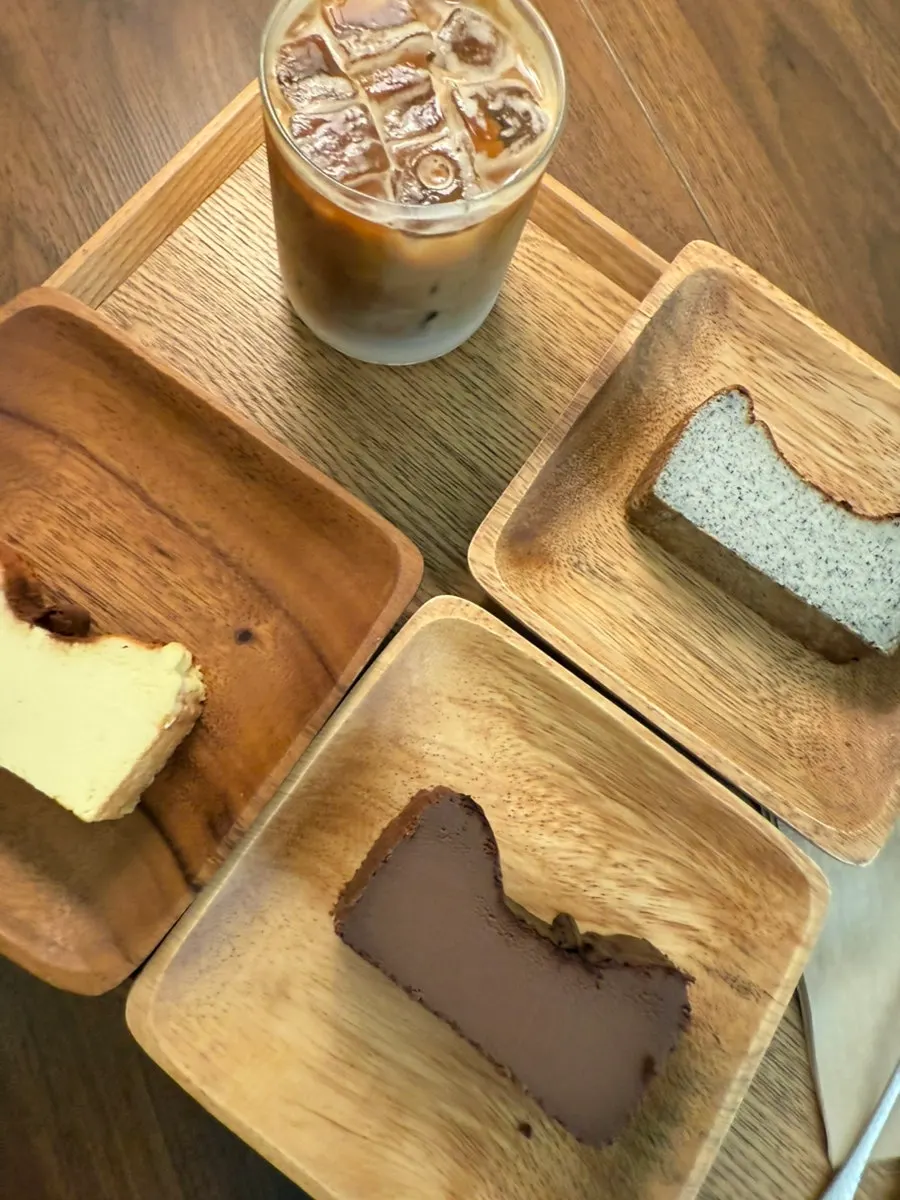 Three Basque cheesecakes with an iced café latte