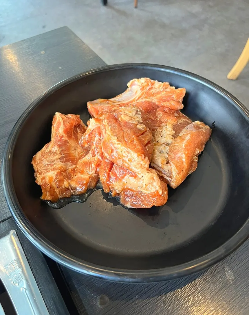 Garlic and stir-fried kimchi in a stainless bowl