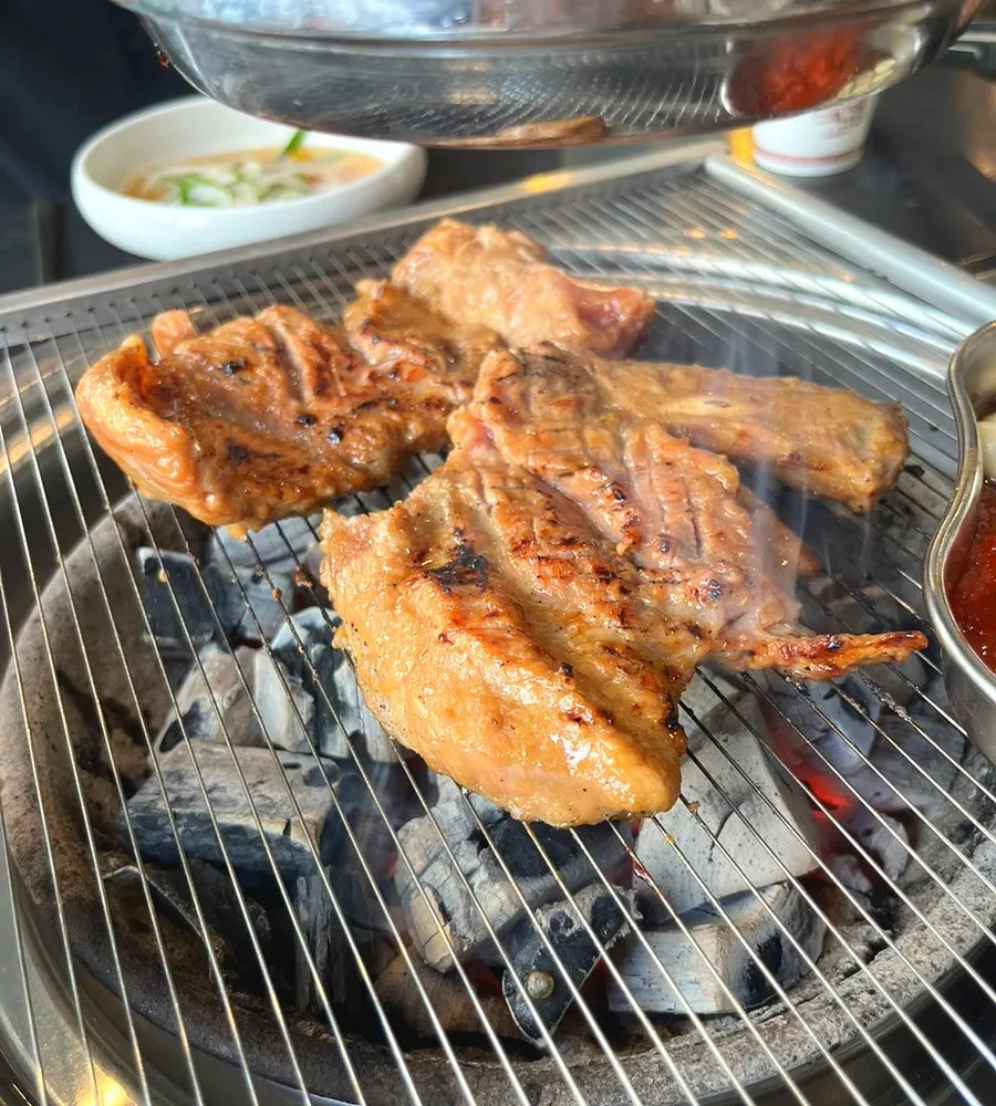 Marinated galbi cooking on the grill at Manpo Galbi