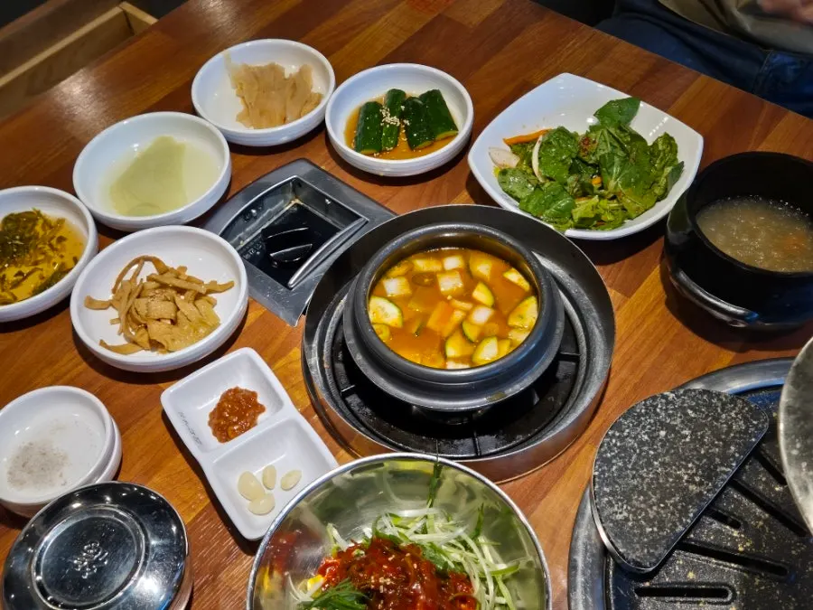 A spread of basic side dishes including scallion salad and lettuce salad