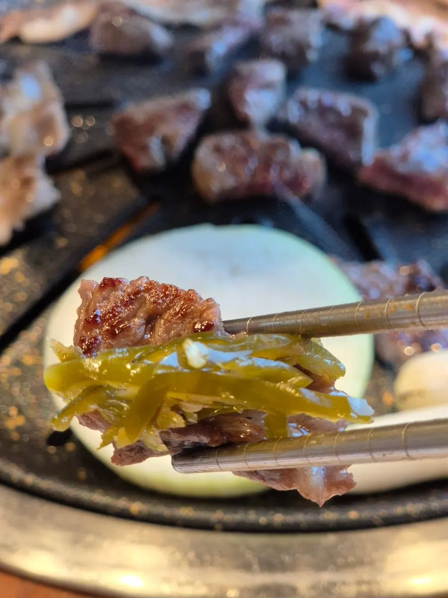 Pickled peppers placed on top of the meat