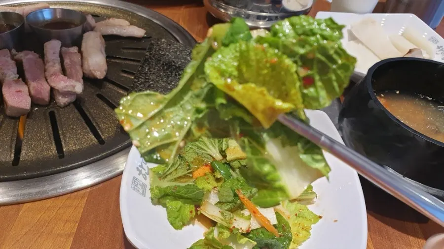 A piece of pork belly wrapped in pickled radish