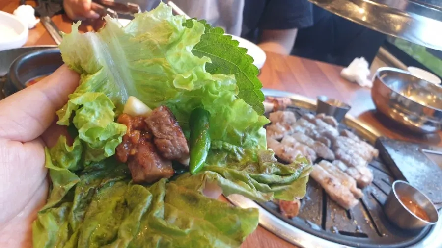 Meat placed on a leafy wrap