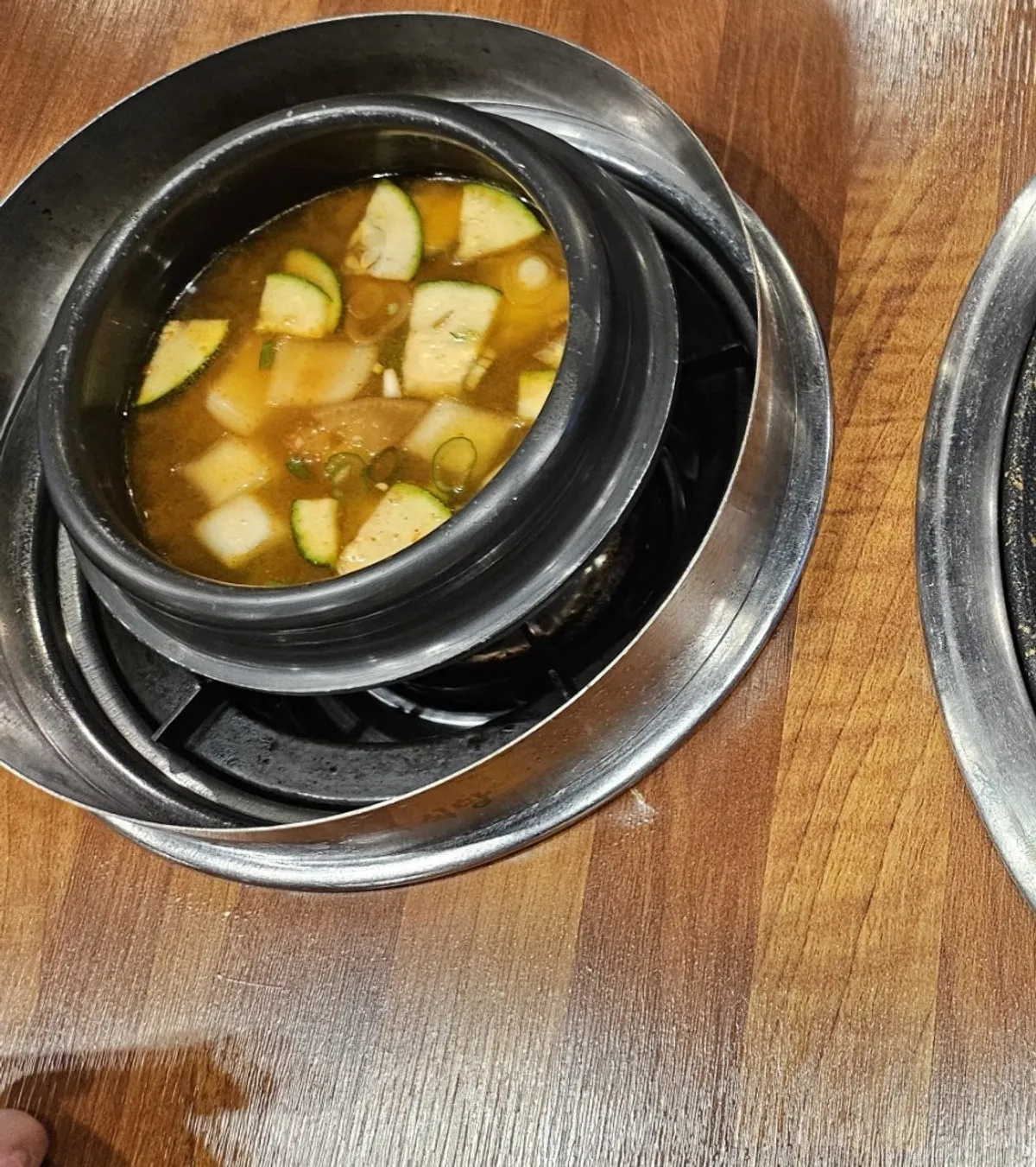 Pot of doenjang jjigae simmering