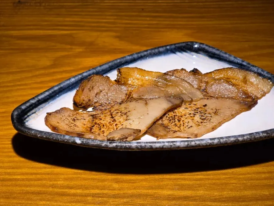 Extra chashu served separately on a plate