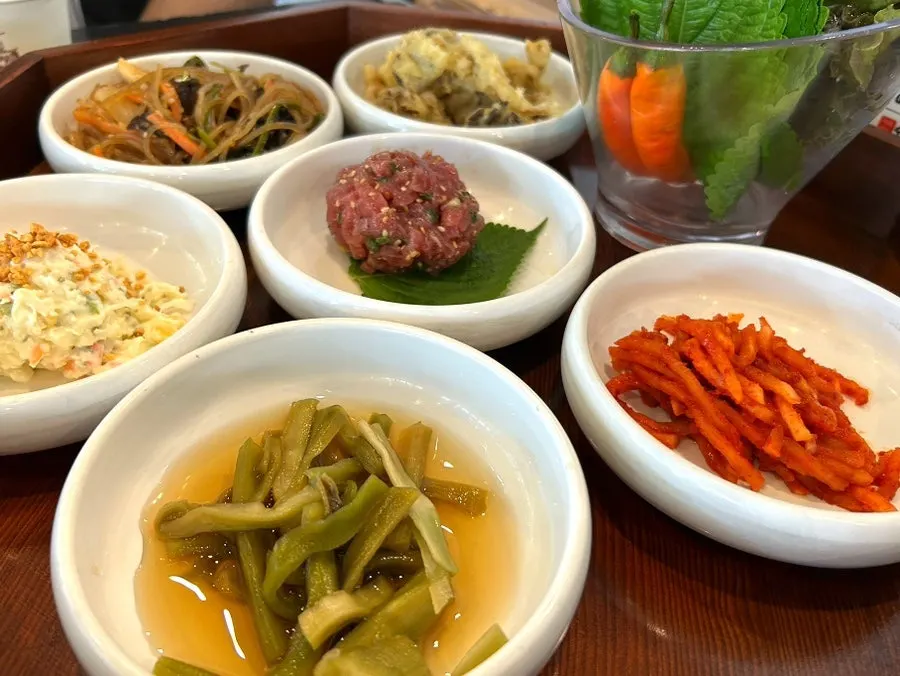 Neatly arranged table of basic side dishes at Manpo Galbi