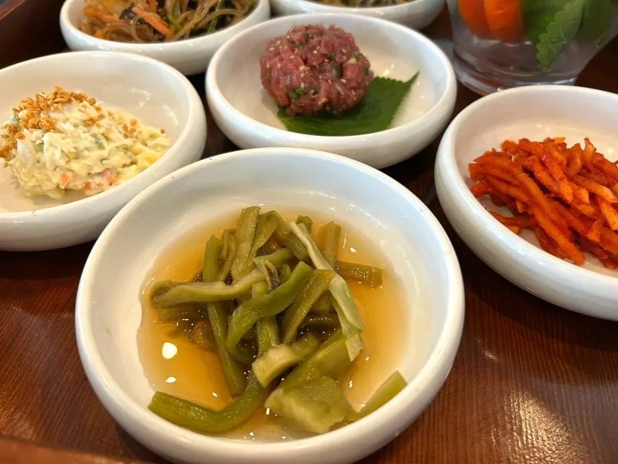 Plate of japchae, fried mushrooms and other side dishes