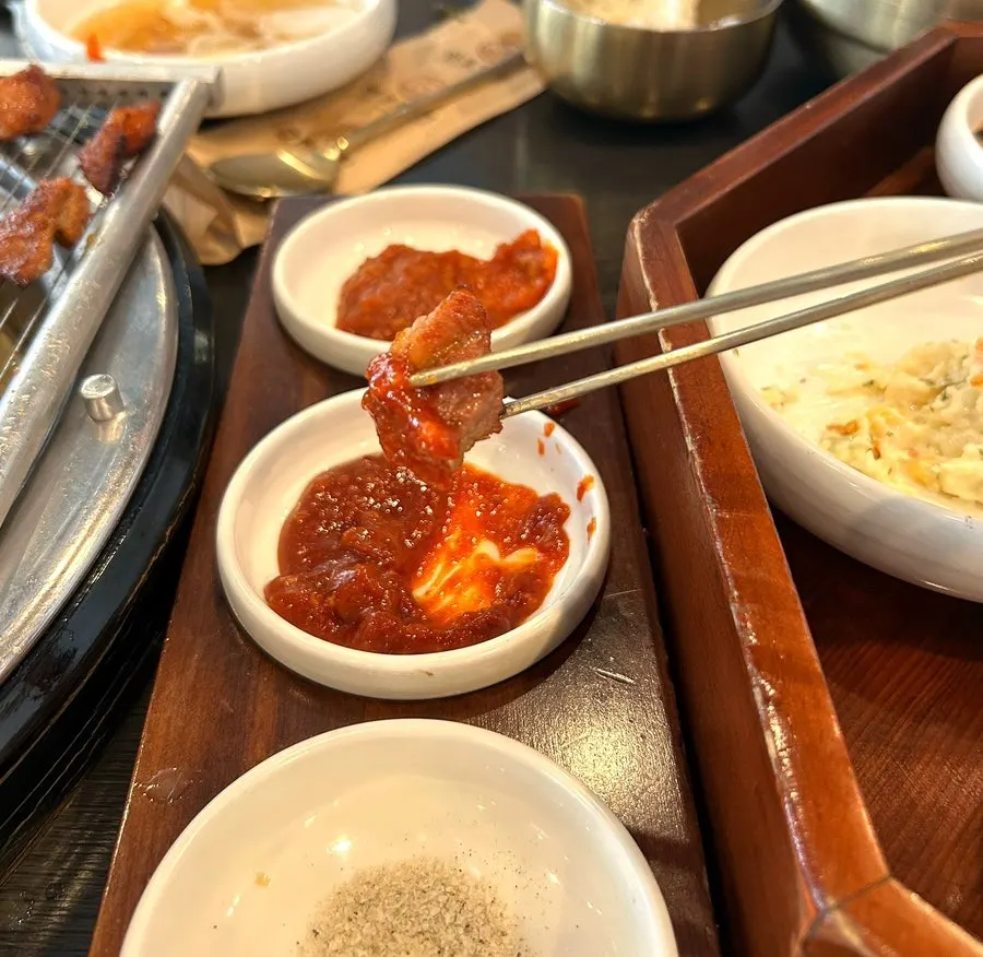 Table setting of grilled galbi and wrap greens