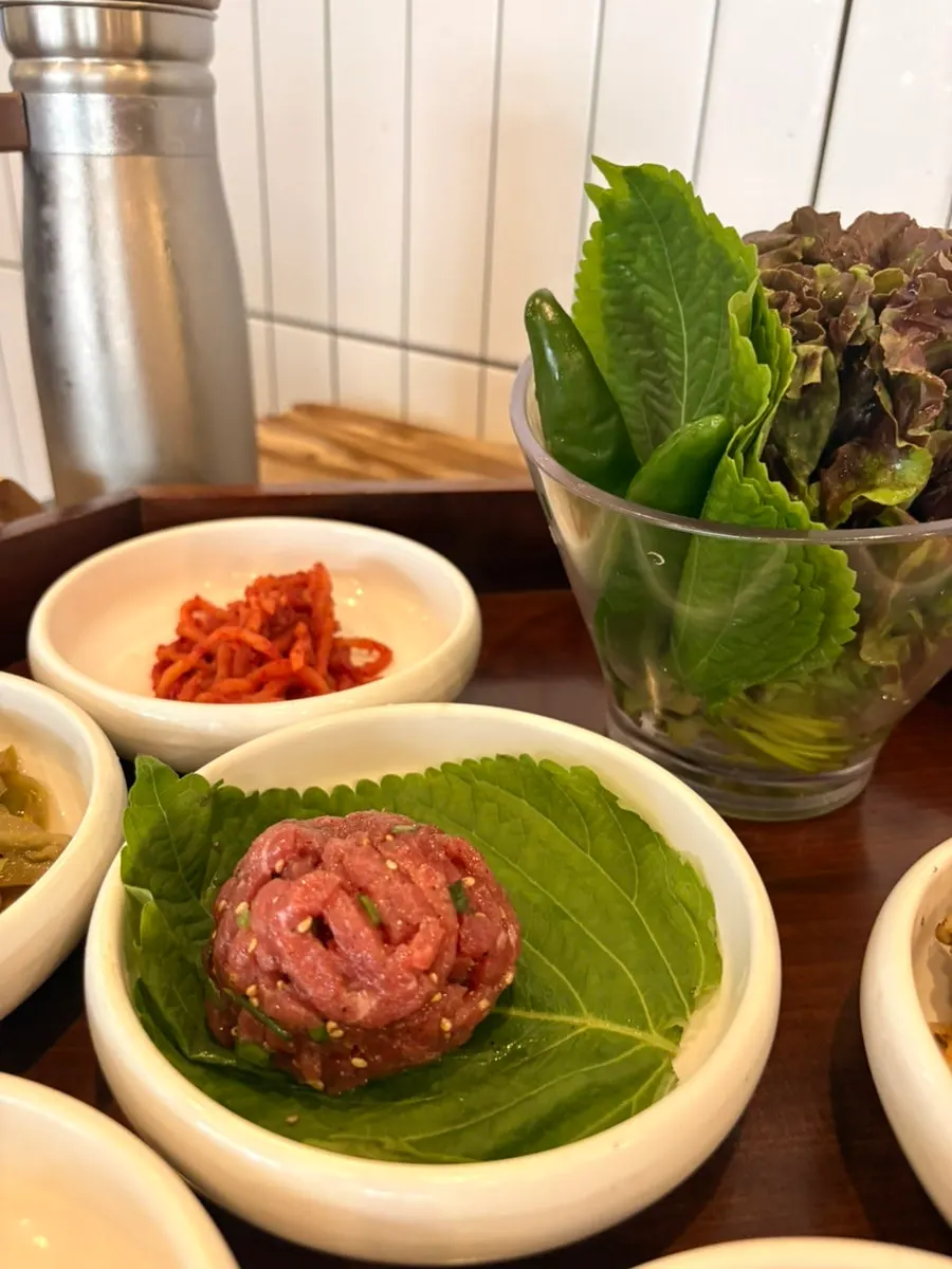 A plate of yukhoe served with ssam vegetables
