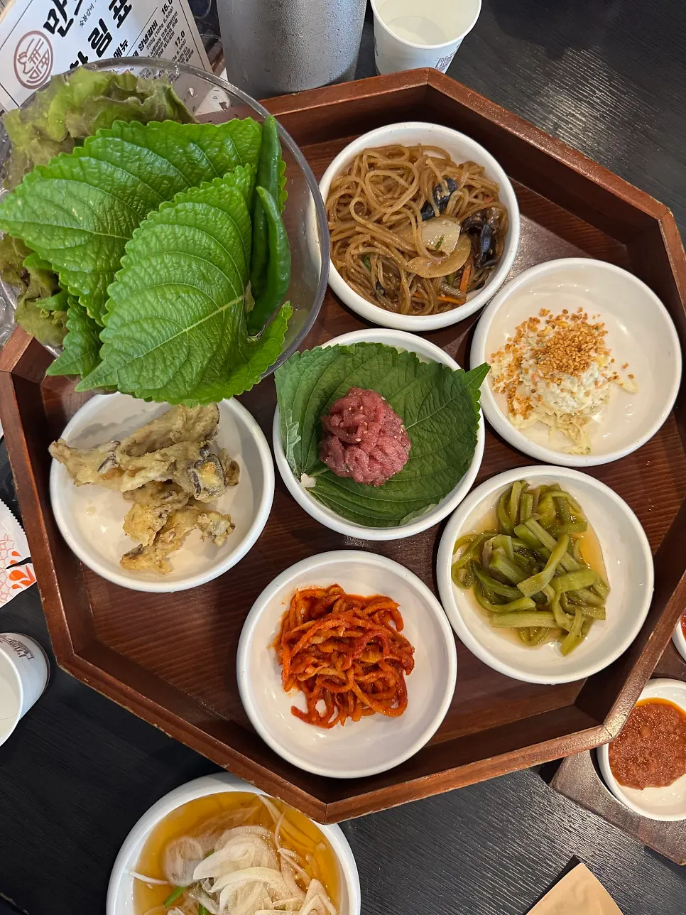 Standard side dishes at Manpo Galbi including japchae and gungchae namul