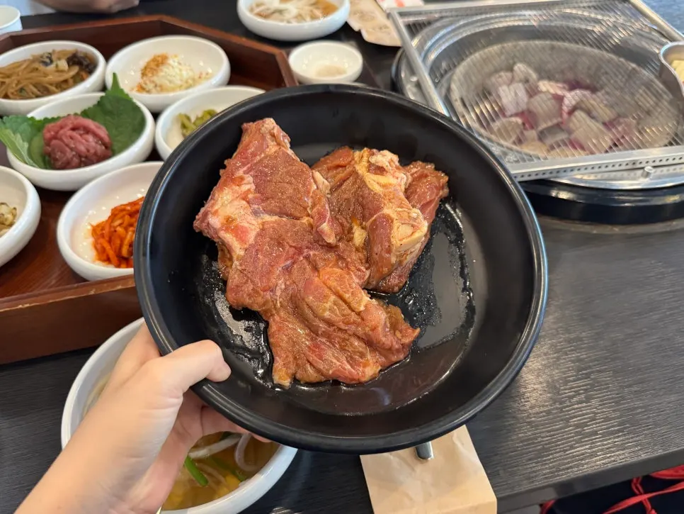 Thick marinated pork galbi grilling over charcoal