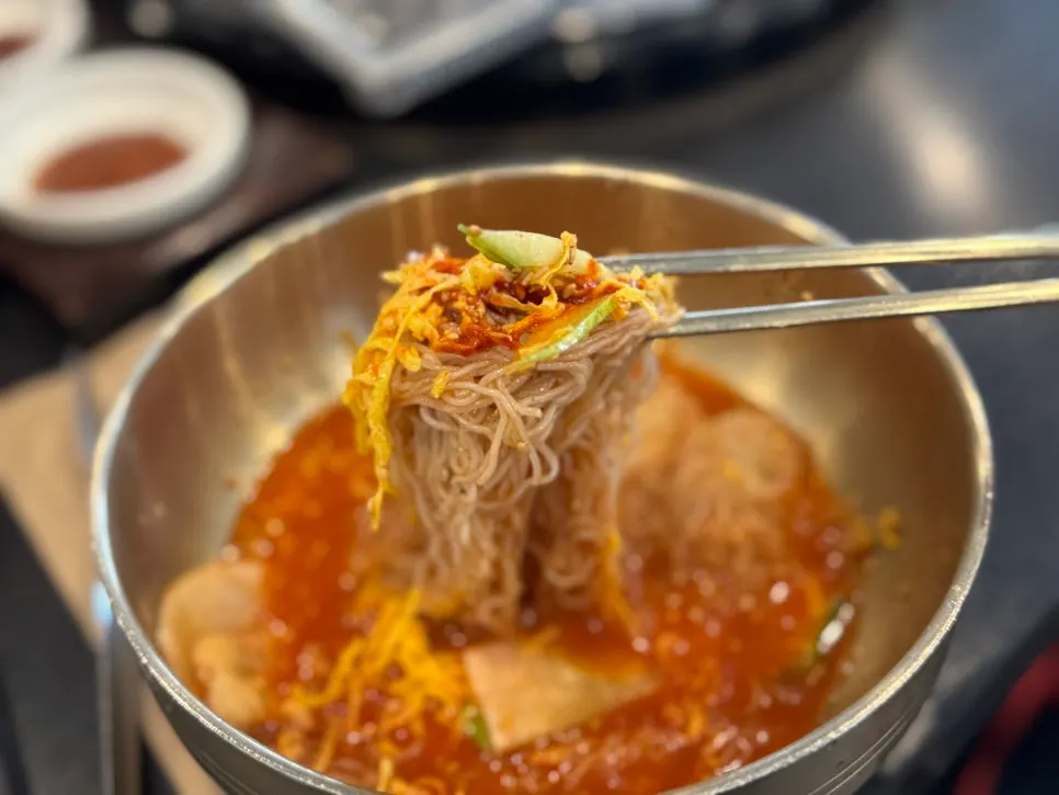 Spicy mixed naengmyeon tossed with its sauce