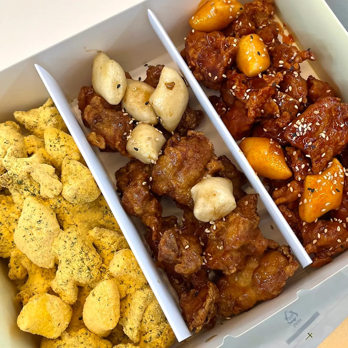 Takeout set with pickled radish, shrimp chips, and skewers